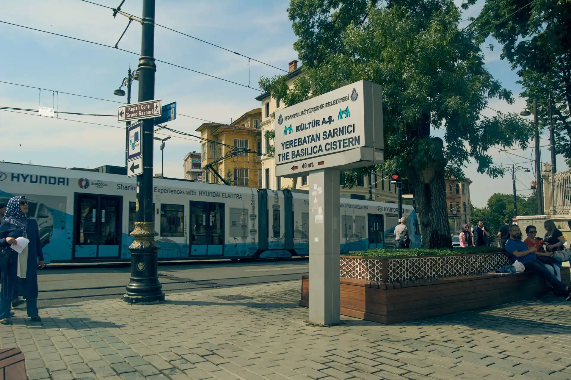 A city tram passing the Basilica Cistern street sign in Sultanahmet, Istanbul